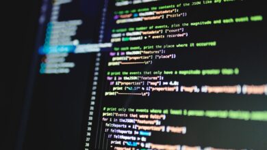 Close-up of colorful programming code displayed on a computer monitor with a dark background.