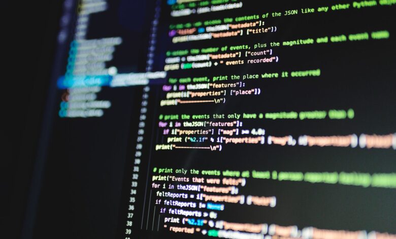 Close-up of colorful programming code displayed on a computer monitor with a dark background.