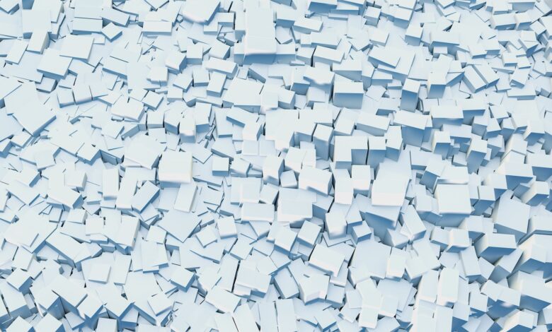Abstract digital illustration of scattered white geometric blocks creating a textured background.