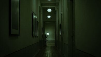 Explore the moody atmosphere of a narrow corridor with green lighting and hanging lamps.