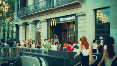 Crowded street scene outside McDonald's with diverse pedestrians.
