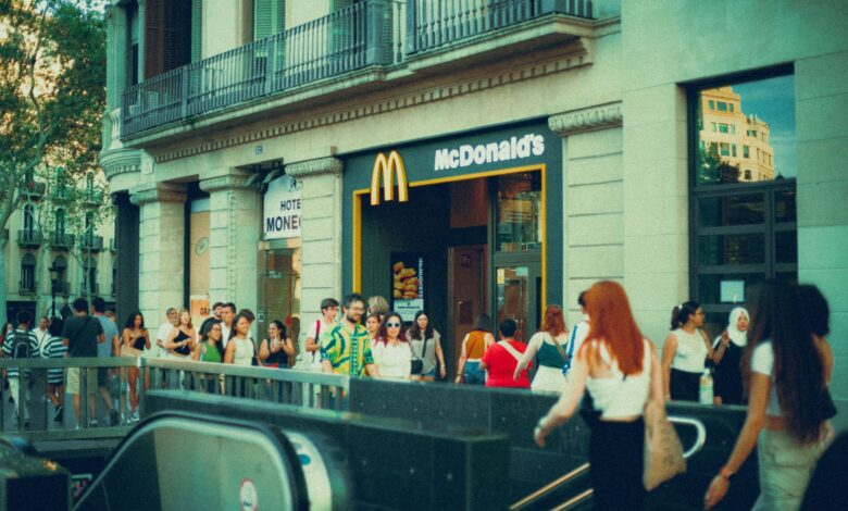 Crowded street scene outside McDonald's with diverse pedestrians.