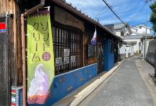 Charming wooden shop on a quiet Japanese street, showcasing traditional architecture.