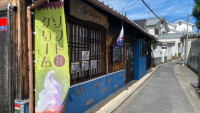 Charming wooden shop on a quiet Japanese street, showcasing traditional architecture.