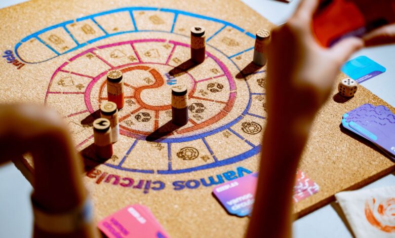 Players engaging in a vibrant strategy board game with colorful pieces and cards.