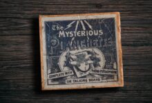 Antique mysterious planchette game board on rustic wooden surface.