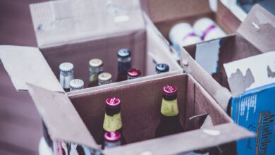 Variety of beer bottles displayed in open cardboard boxes.