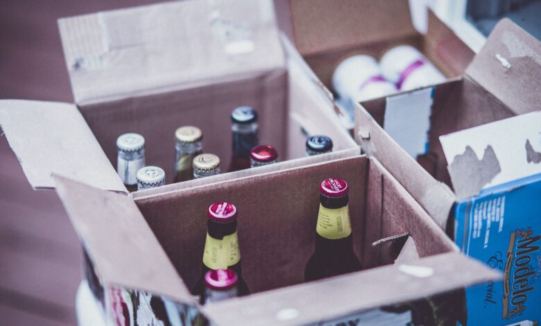 Variety of beer bottles displayed in open cardboard boxes.