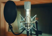Close-up of a studio microphone with pop filter, perfect for recording.