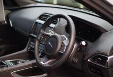 Stylish interior of a luxury car featuring a sleek dashboard and modern controls for a premium driving experience.