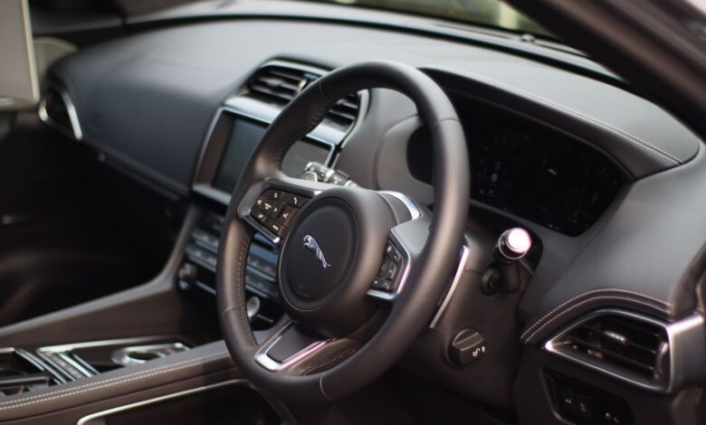 Stylish interior of a luxury car featuring a sleek dashboard and modern controls for a premium driving experience.