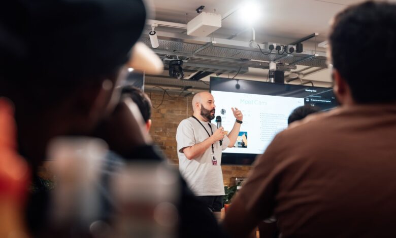 Engaging speaker presenting to an attentive audience during a tech event in London.