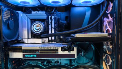 Close-up of an advanced gaming desktop PC with GeForce RTX, liquid cooling, and RGB lighting.