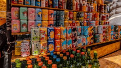 Vibrant display of Korean drinks and sodas at a bustling market in Mexico City.