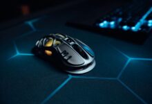 High-tech gaming mouse on illuminated hexagonal pattern mousepad, perfect for gamers.