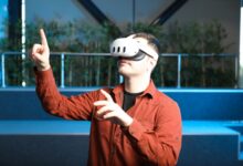 A man wearing a VR headset interacts with augmented reality indoors.