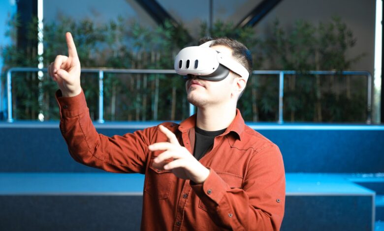 A man wearing a VR headset interacts with augmented reality indoors.