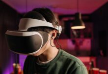 A person immersed in virtual reality using a VR headset and headphones indoors.