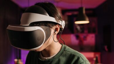 A person immersed in virtual reality using a VR headset and headphones indoors.