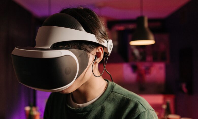 A person immersed in virtual reality using a VR headset and headphones indoors.