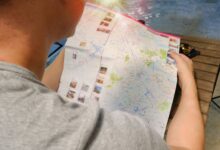 Traveler studying a map for directions, symbolizing exploration and adventure.