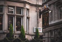 A traditional pub facade in London showcases classic architecture with detailed signage.