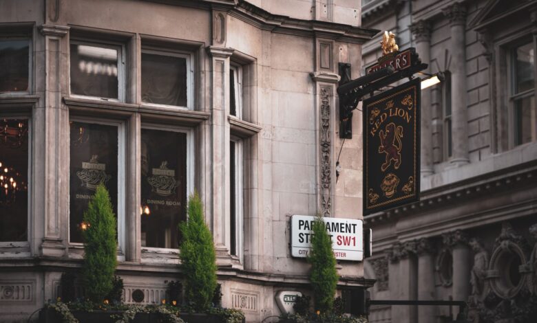 A traditional pub facade in London showcases classic architecture with detailed signage.