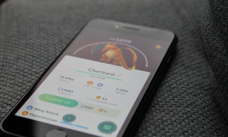 Smartphone displaying Pokémon GO screen with Charizard, highlighting gaming technology.