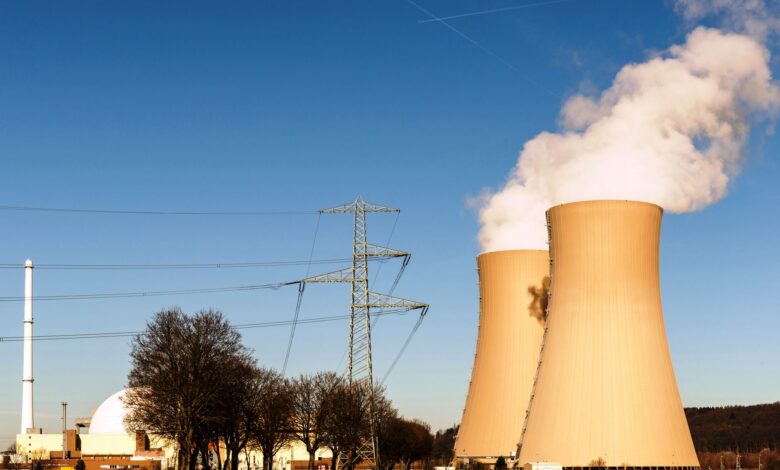 A nuclear power plant in Hameln, Germany, showcasing cooling towers and electricity pylons.