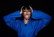 Creative Halloween portrait of a woman in a karate uniform with vampire makeup.