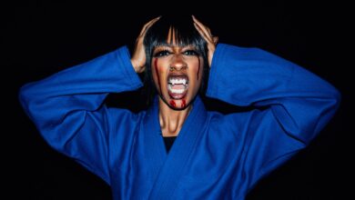 Creative Halloween portrait of a woman in a karate uniform with vampire makeup.