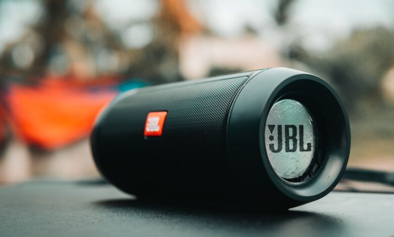 Focused shot of a black JBL portable speaker on a surface, ideal for technology concepts.