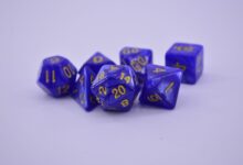 Close-up of purple polyhedral dice on a white surface, perfect for tabletop gaming enthusiasts.
