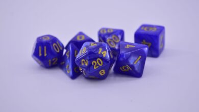 Close-up of purple polyhedral dice on a white surface, perfect for tabletop gaming enthusiasts.