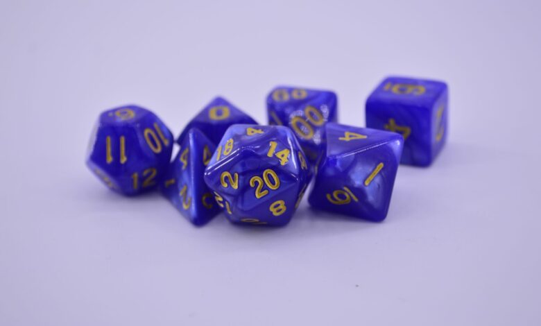 Close-up of purple polyhedral dice on a white surface, perfect for tabletop gaming enthusiasts.