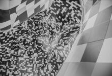 Abstract image featuring a black and white checkered pattern with pixelated forms.