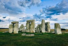 Scenic view of Stonehenge with a dramatic sky in England, showcasing ancient megalithic stones.