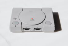 A classic Sony PlayStation console captured on a white background exuding retro gaming nostalgia.