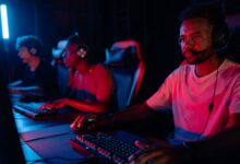 Young men engrossed in a competitive eSports gaming session, displaying teamwork and focus.