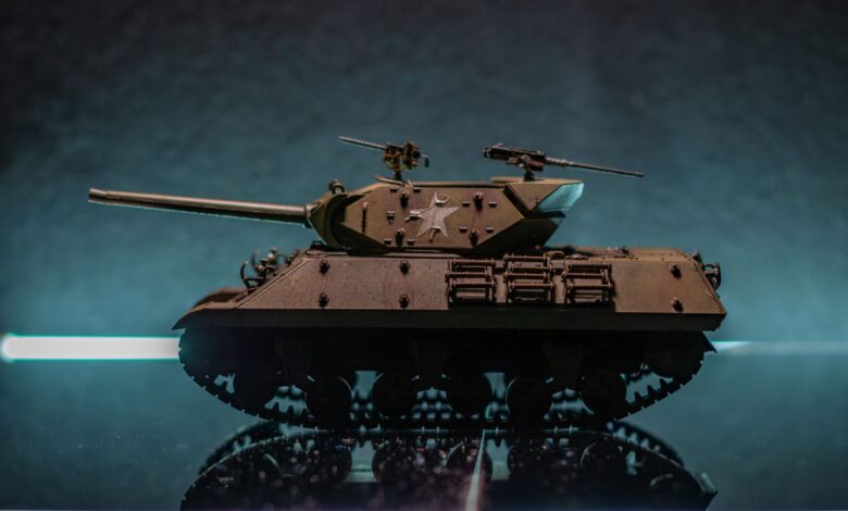 A detailed model of a military tank on a reflective surface with a dramatic background.