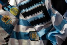 Close-up of Argentina soccer jerseys featuring national emblems and iconic designs.