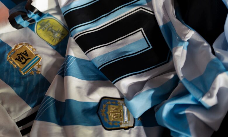 Close-up of Argentina soccer jerseys featuring national emblems and iconic designs.