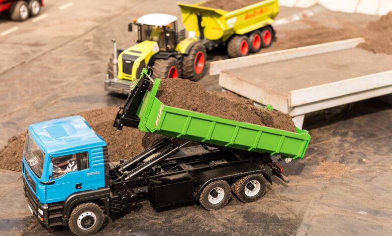 High-angle view of toy trucks on a model construction site showcasing a realistic mini landscape.