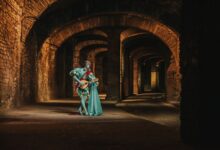 A costumed bard playing a lute in a mystical medieval hallway, evoking fantasy themes.