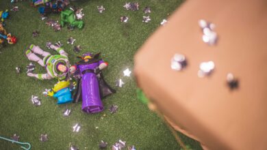 Buzz Lightyear and Zurg toy figures on artificial grass surrounded by star-shaped decorations.