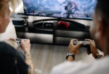 Two friends enjoying a video game session indoors using controllers, focusing on teamwork and fun.