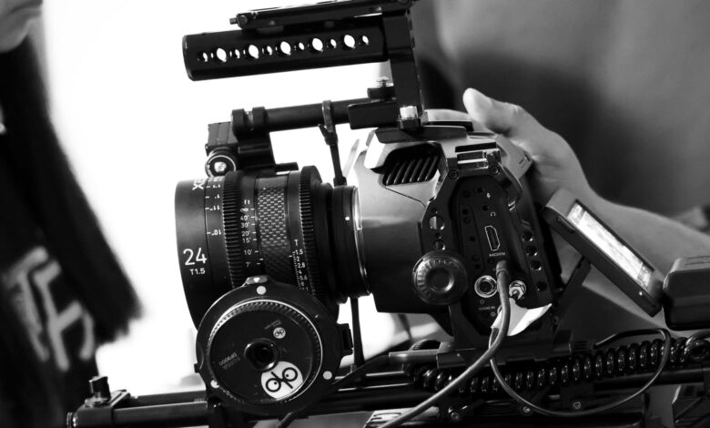 Detailed view of a professional movie camera rig in black and white, showcasing filmmaking equipment.