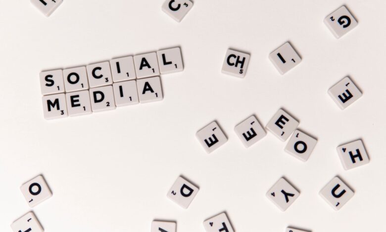 Scrabble tiles spelling 'Social Media' on a white background, symbolizing digital communication.