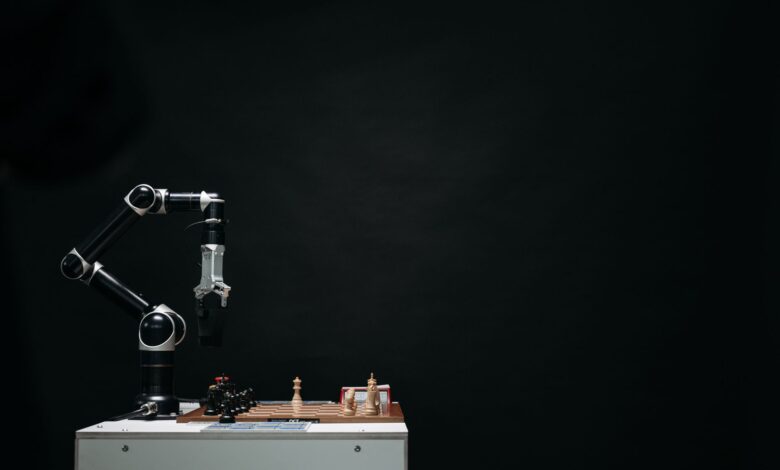 An articulated robotic arm competes in chess on a board against a dark background, highlighting AI and innovation.