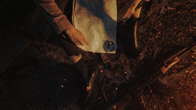 A person planning a journey using a map, compass, and military gear in a rugged outdoor setting.